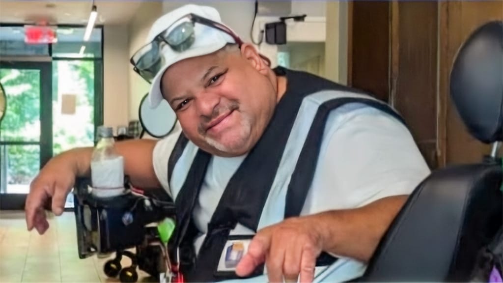 Angel using the refurbished mobility scooter that restored his independence.