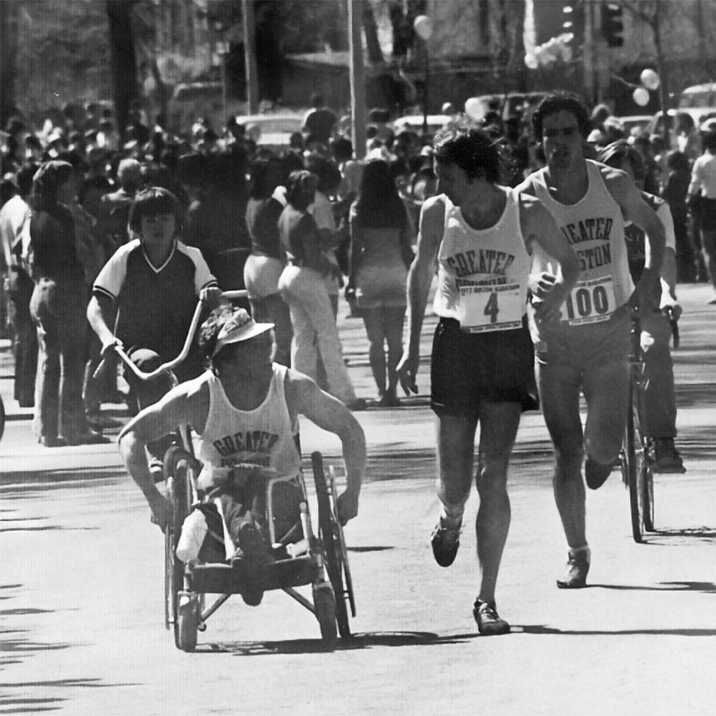Bob Hall pushing his racing wheelchair on the Boston Marathon course in 1975.